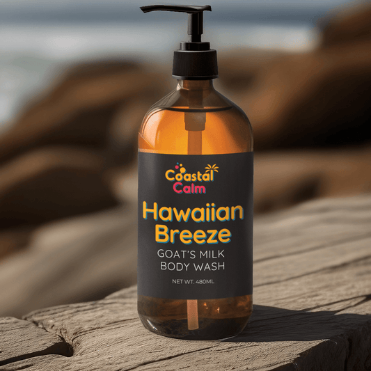 Bottle of Coastal Calm Hawaiian Breeze Goat's Milk Milk Body Wash on a wooden surface with a blurred natural background