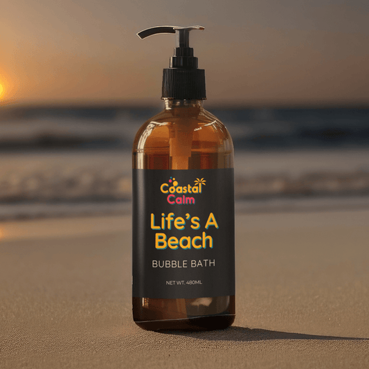 Coastal Calm bubble bath bottle on a beach with sunset in the background