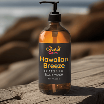 Bottle of Coastal Calm Hawaiian Breeze Goat's Milk Milk Body Wash on a wooden surface with a blurred natural background