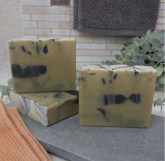 Pine Soap Detox Bar with charcoal and moringa, featuring a marbled green and black design, ideal for skin detox and nourishment.